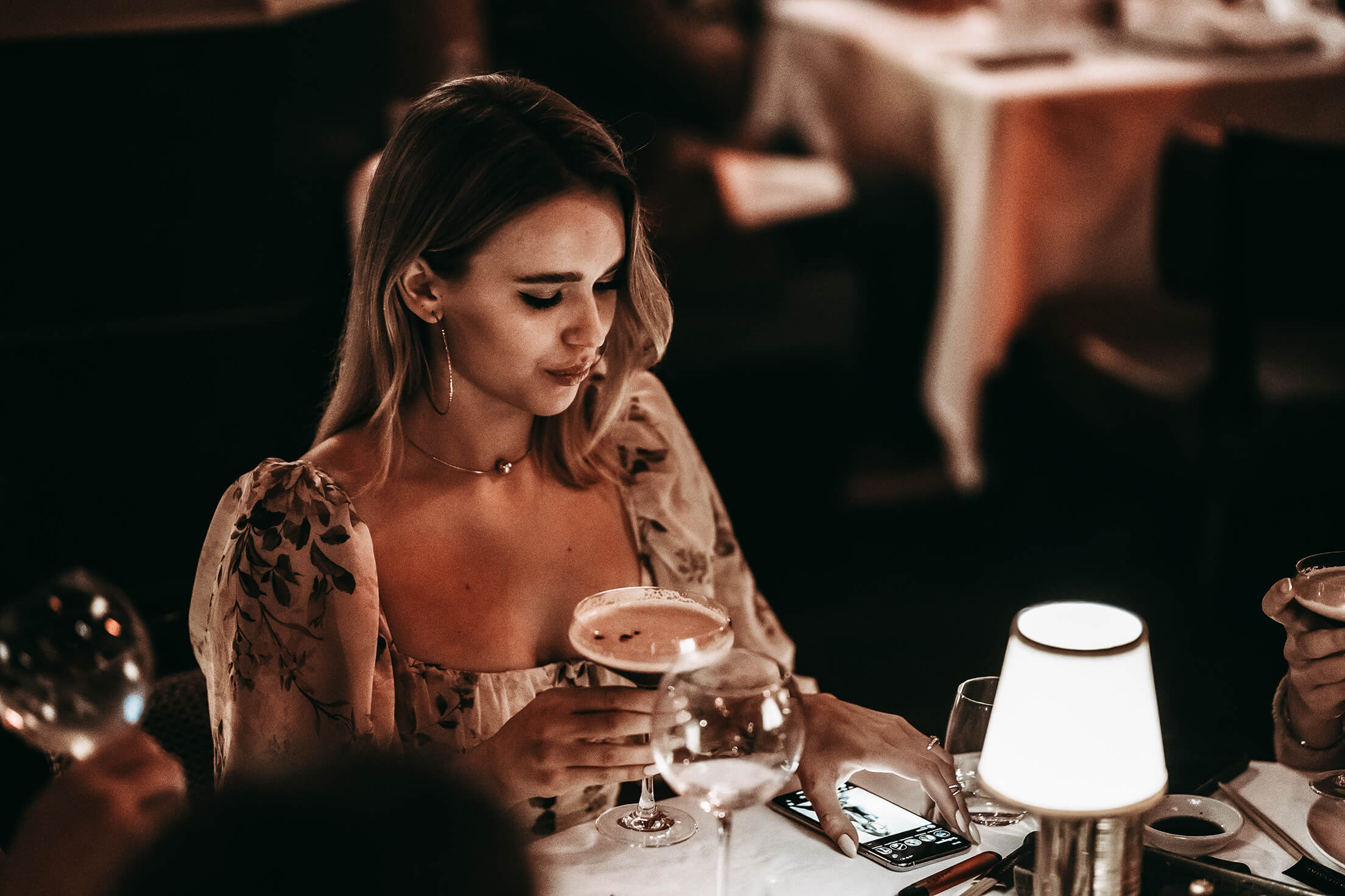 Woman with a drink and phone