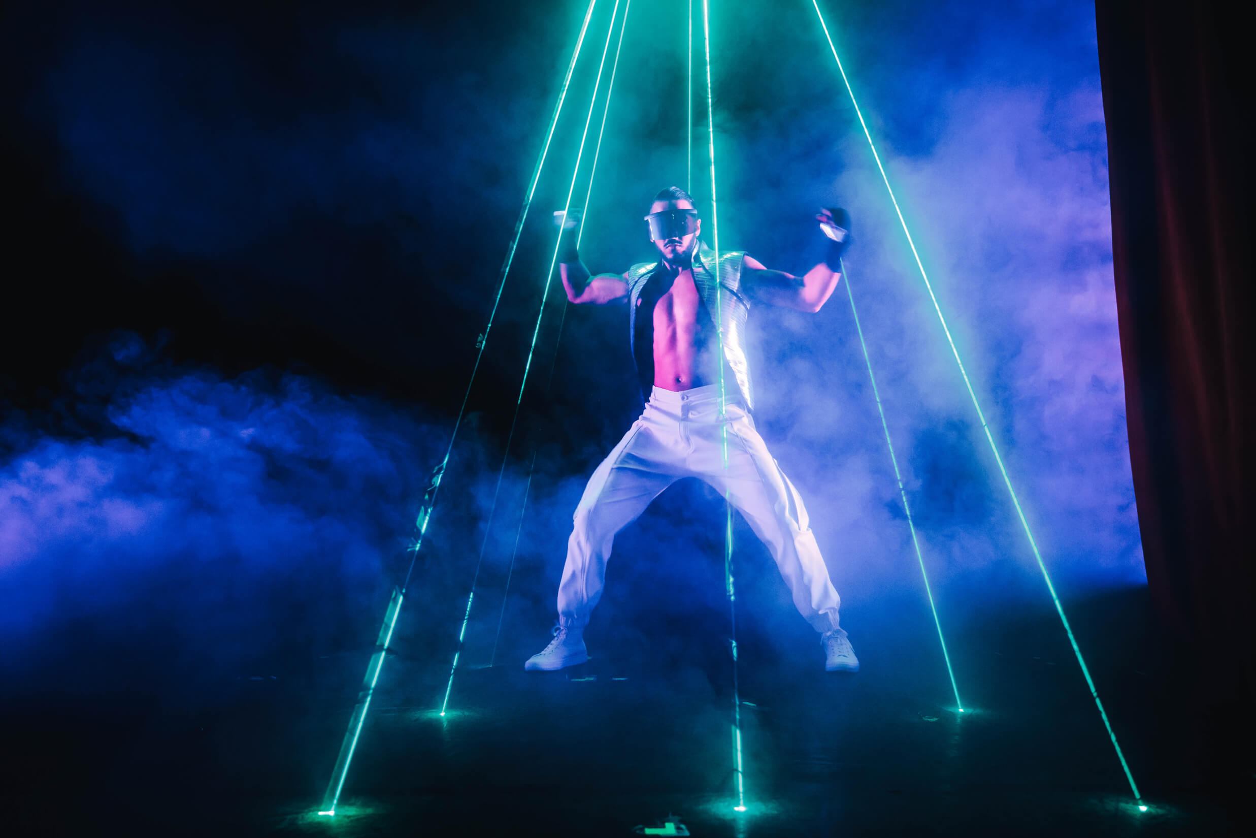 Billionaire performer on stage with lasers
