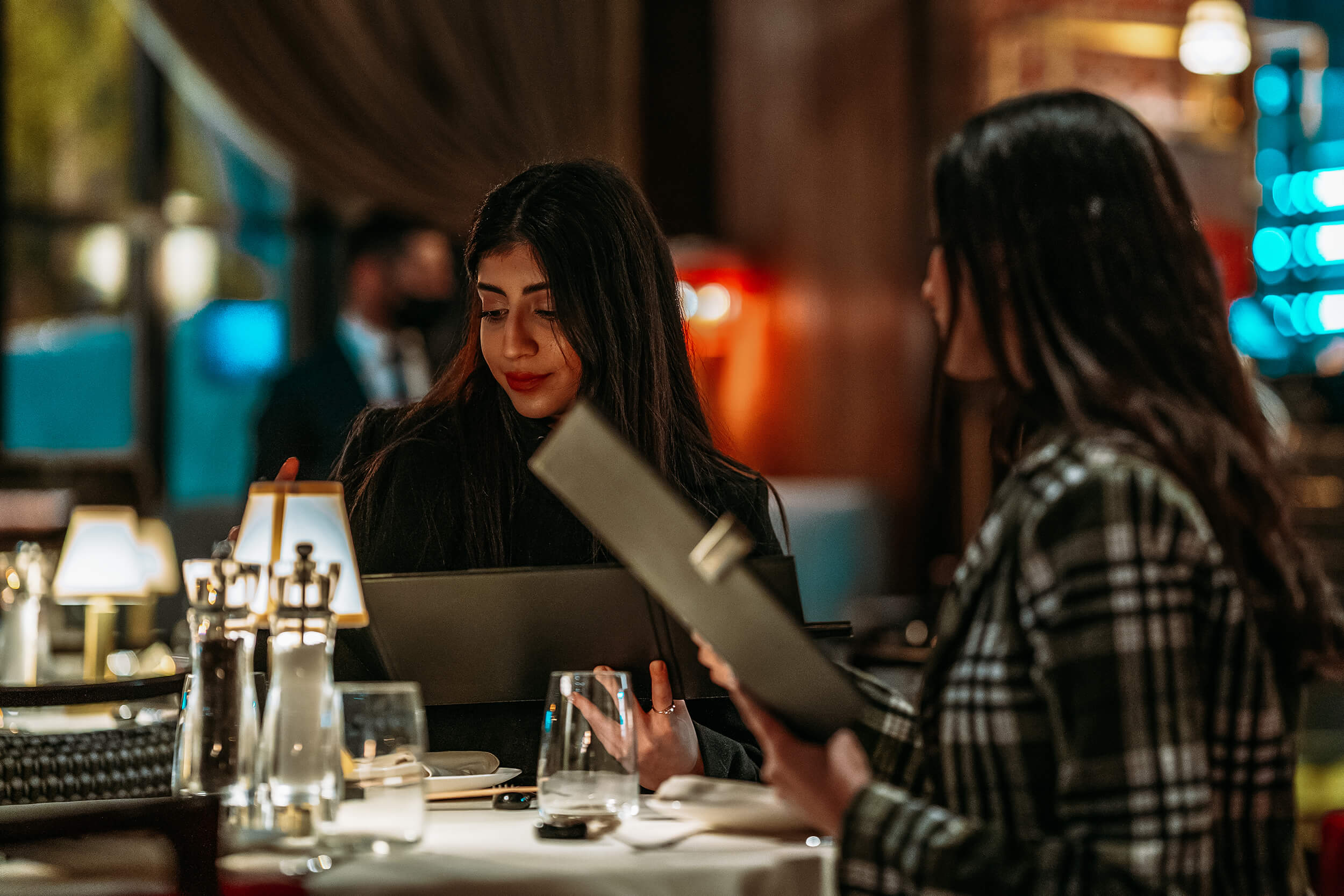 two women looking at menus